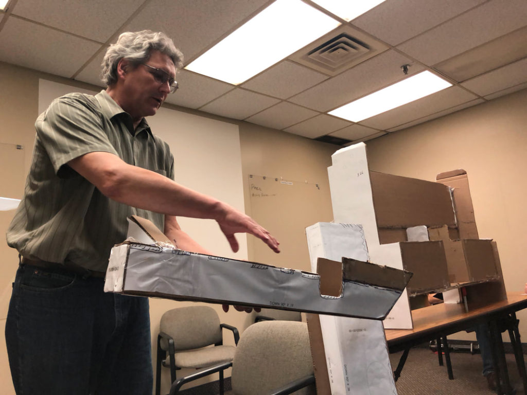 Engineer working to design parts in machine shop