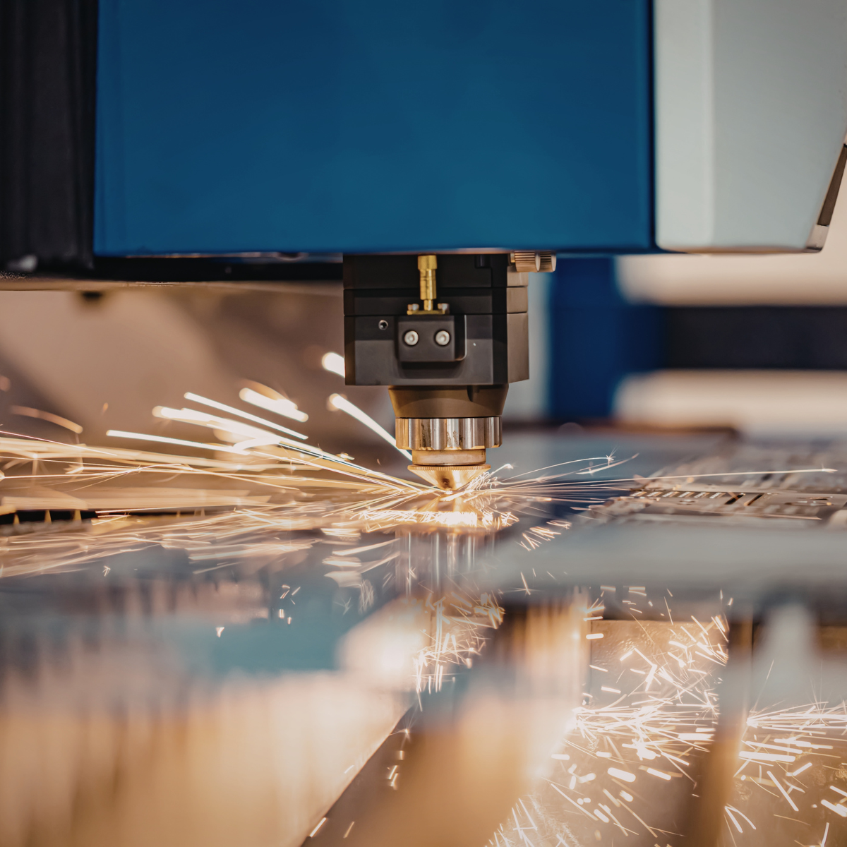 Precision laser cutting machine slicing through a piece of sheet metal