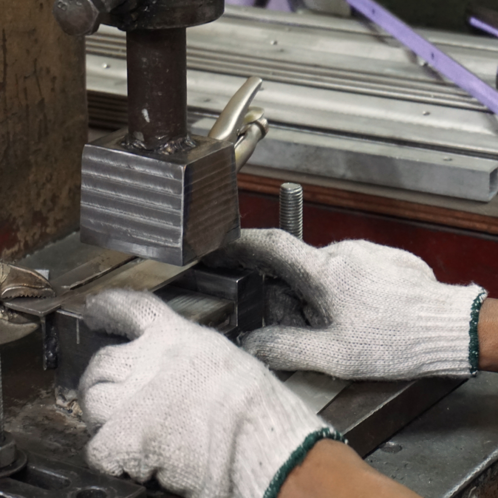 Machinist working metal stamping machine